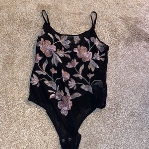 One piece flowered bodysuit . See through material
